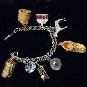 Vintage gold toned and silver bracelet, eight charms